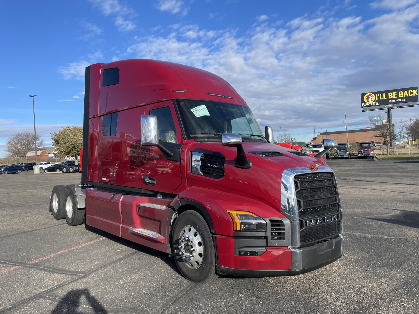 Mack PR64T76H tractor truck in red, side view with sleeper cab and front grille.