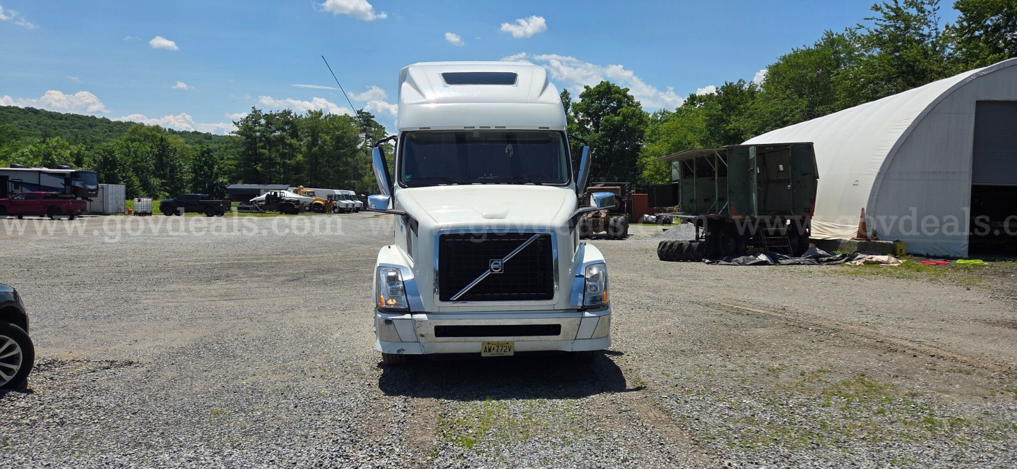 Volvo VNL truck front view showing grille and headlights in a gravel lot.