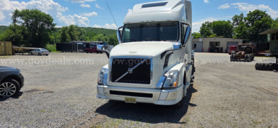  Volvo VNL truck in a used inventory lot front view with white cab and chrome grille showing Volvo badge.