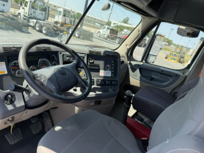 Cab interior of a 2017 Freightliner Cascadia CA125DC with steering wheel, dashboard, and driver seat visible.