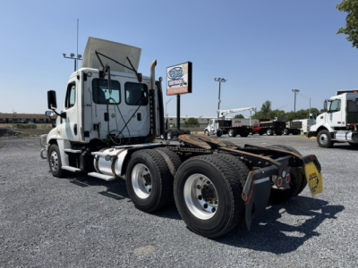 Freightliner Cascadia CA125DC tractor rear view showing fifth wheel and dual rear axles with chrome wheels and a raised cab, VIN 3AKJGEDV4HSHR3350 visible