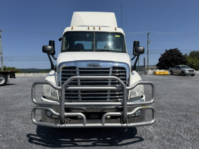 Vehicle nose of a white Freightliner Cascadia daycab showing front bumper guard and grille with large mirrors