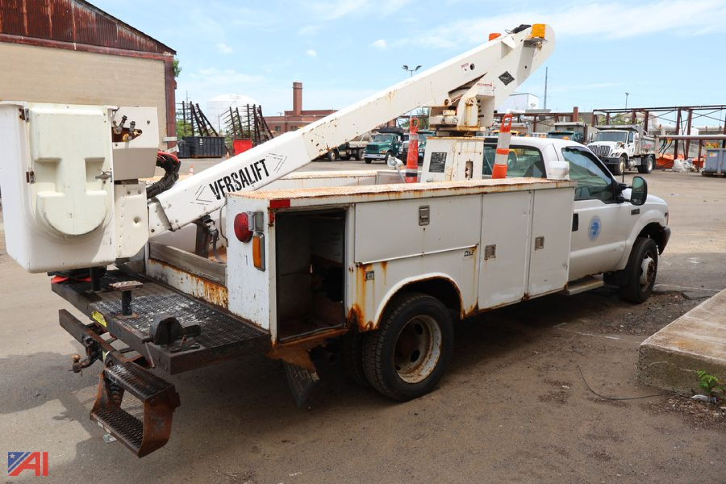 Ford F-450 Super Duty utility bucket truck with service compartments and crane boom viewed from rear-left side.