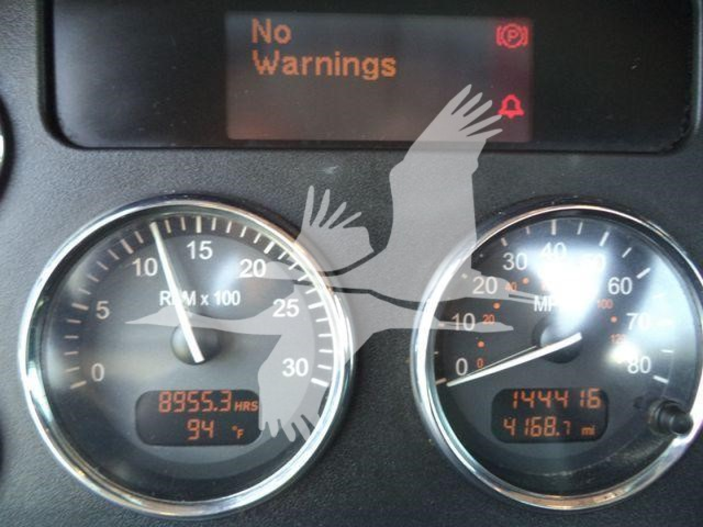 Peterbilt 337 dashboard showing two gauges with odometer and elapsed hours, digital display reading 8955.3 HRS and 94�, other gauge shows 14441.6 miles and 4168.1 mi, No Warnings on screen.