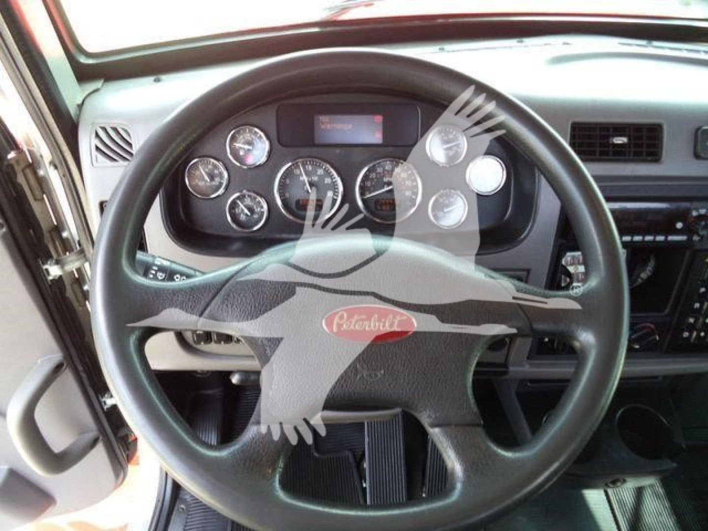 Peterbilt 337 dashboard and steering wheel view showing gauges and controls