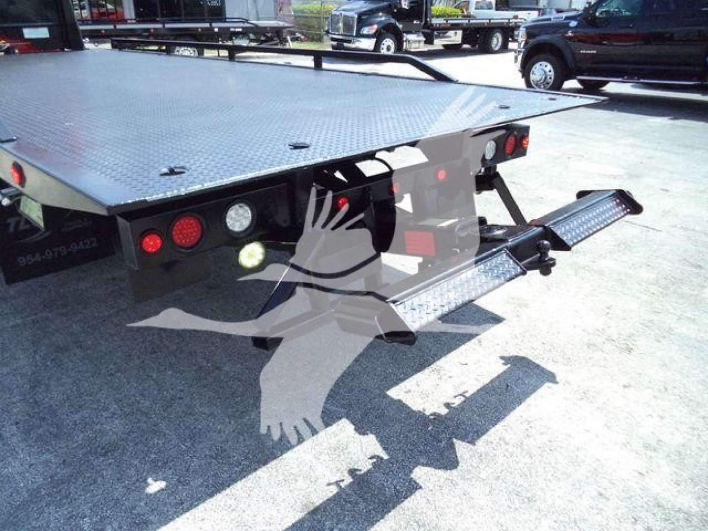 Peterbilt 337 rollback truck bed rear view showing diamond plate platform and loading ramps