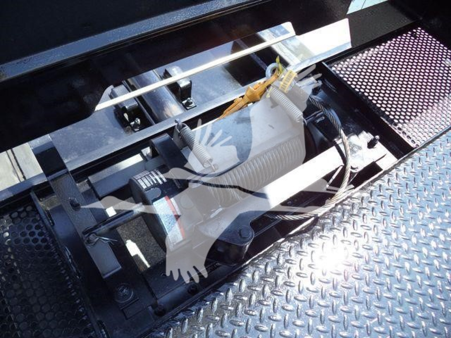 Peterbilt 337 rollback truck engine bay area showing hydraulic or power unit with cables and diamond plate platform visible.