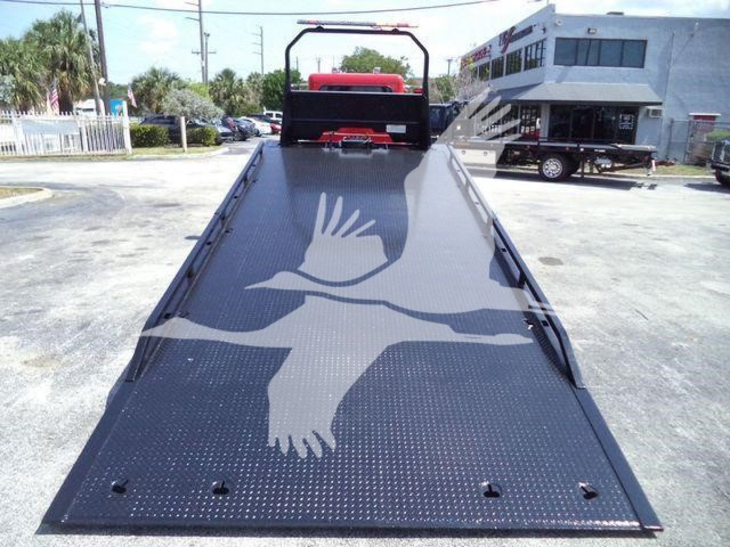 Peterbilt 337 rollback truck flatbed viewed from rear with diamond plate surface and loading ramp.
