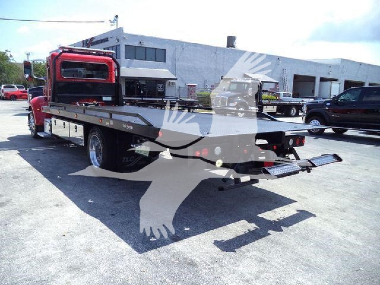 Peterbilt 337 rollback tow truck viewed from rear-left side showing flatbed and tow equipment.