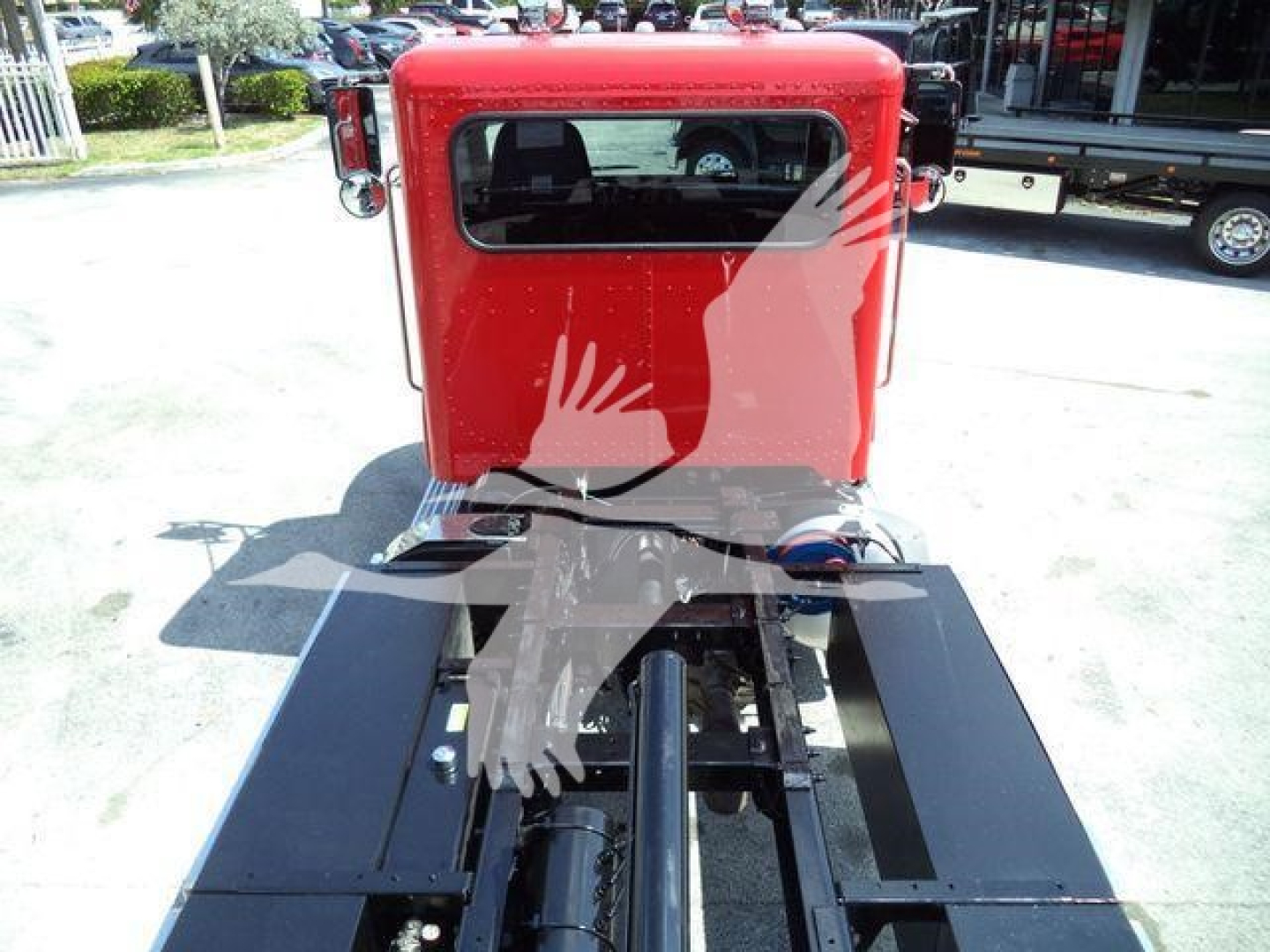 2021 Peterbilt 337 truck cab rear view showing red cab and hitch area, rollback equipment mounts visible.