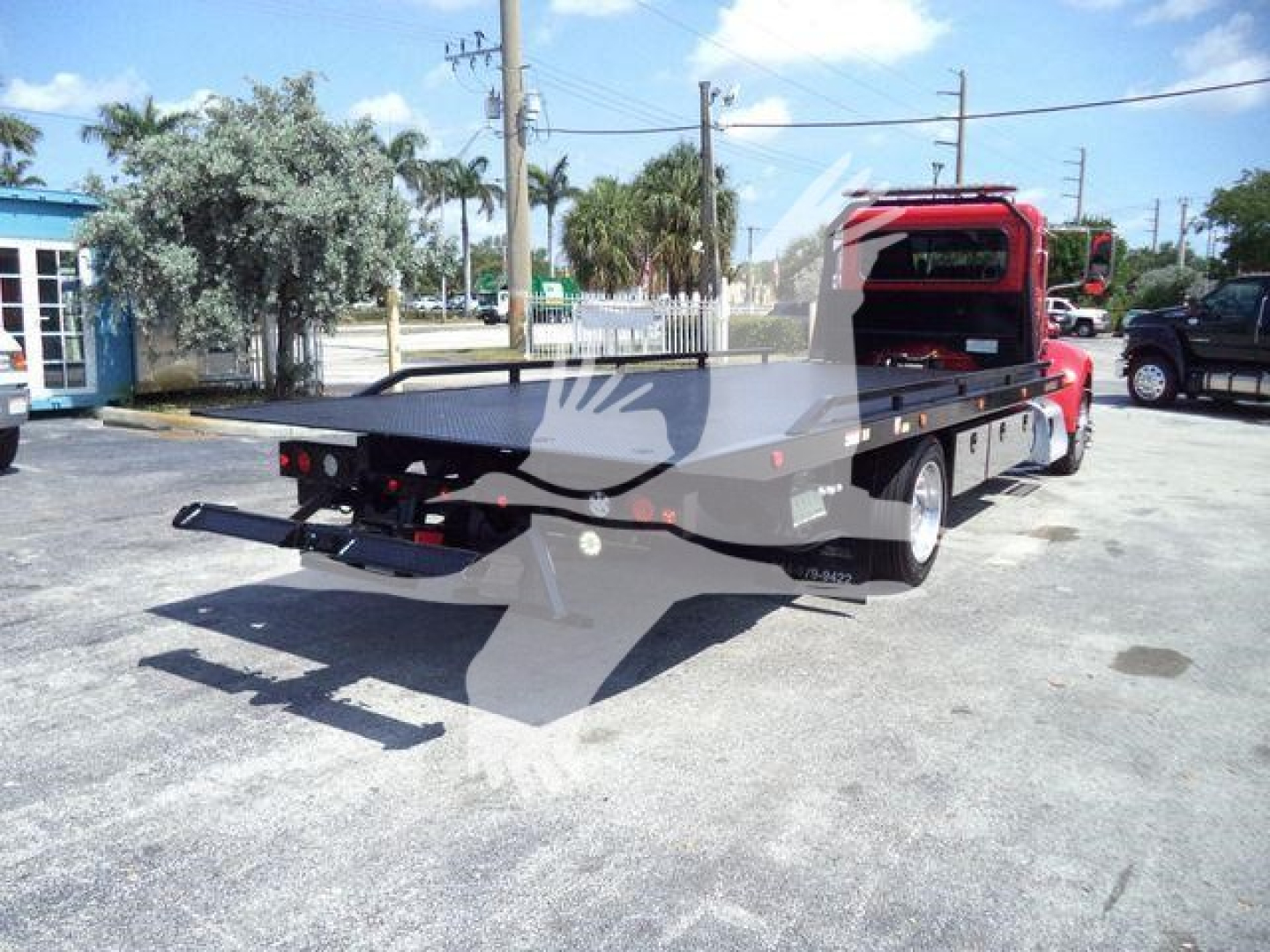 Peterbilt 337 rollback truck rear/left side view showing flatbed and towing apparatus.