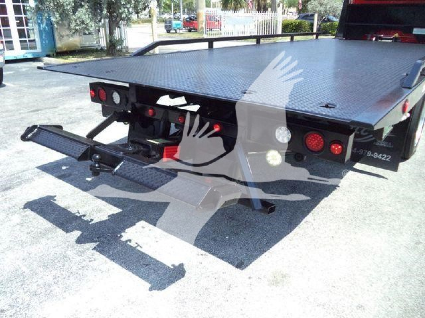 Peterbilt 337 rollback truck rear with loading ramp and platform. Visible hydraulic platform and taillights.