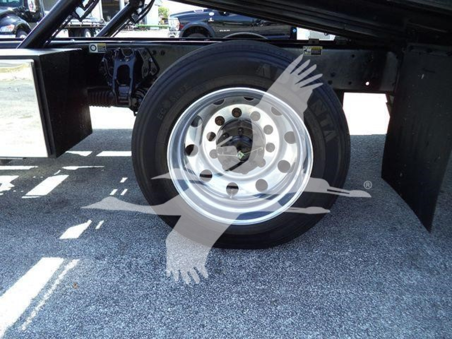 Peterbilt 337 rollback truck underframe showing rear wheel and frame rails with suspension components; no readable legible labels visible.
