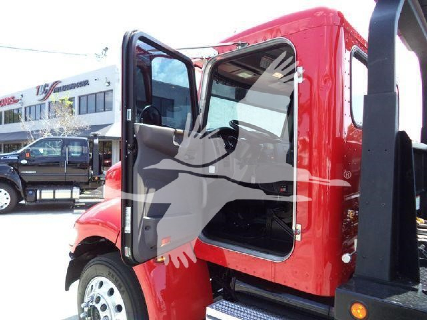 Peterbilt 337 truck cab with open door, red exterior, showing entry steps and interior seating.