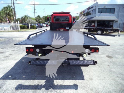 Truck bed of a 2021 Peterbilt 337 rollback tow truck showing flatbed and rear lights.