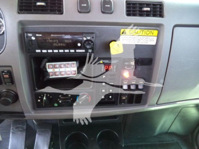 Peterbilt 337 dashboard and control panel showing radio, switch panel, and warning label.