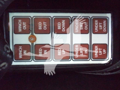 Label with multiple coloured boxes showing switch positions: WINCH OUT, BED OUT, RED DOWN, UNDER LIFT OUT, UNDER LIFT UP, WINCH IN, BED IN.