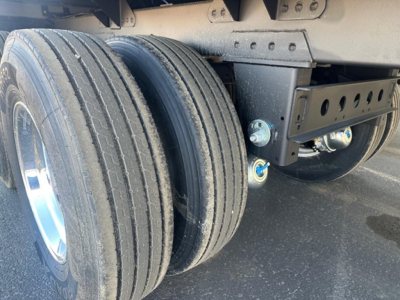 Trailer wheel assembly showing dual tires and suspension components on a Timpte hopper trailer.