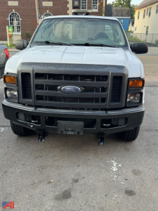 Ford F-250 Super Duty front view showing black grille, headlights, bumper, and Ford emblem.