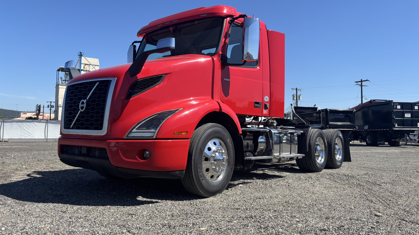 Volvo VNR64T300 truck showing exterior side view with red cab and chassis, no trailer attached.