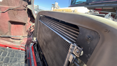 Front view of a Volvo VNR truck engine bay with radiator, cooling fan, and surrounding components visible.