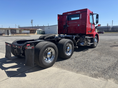 Volvo VNR64T300 tractor cab rear view showing chassis and dual rear axles with mud flaps