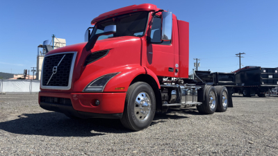 Volvo VNR64T300 truck showing exterior side view with red cab and chassis, no trailer attached.