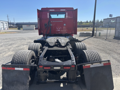 Volvo VNR64T300 truck chassis rear view showing dual rear axles and fifth wheel, with mud flaps and taillights.