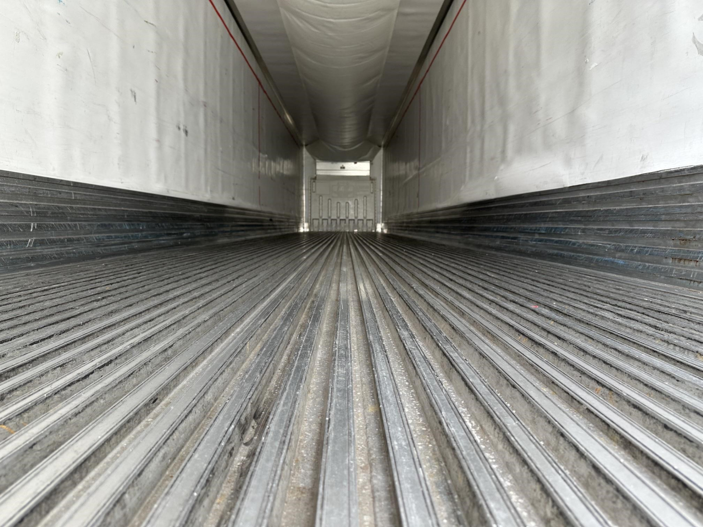 Interior view of a 2015 Utility 3000R trailer cargo area showing corrugated floor and side walls.