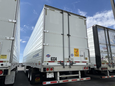 Trailer rear view of a 2015 Utility 3000R refrigerated trailer showing rear doors, bumper, lights, and wheel with stock number 6334.