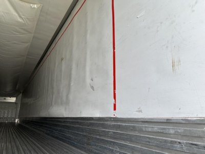 Trailer interior of a 2015 Utility 3000R reefer trailer showing aluminum side walls with a red vertical stripe and ribbed floor.