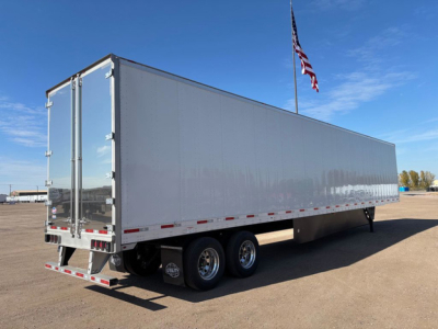 Utility dry van trailer showing exterior side and rear doors with dual rear axles and aluminum body.