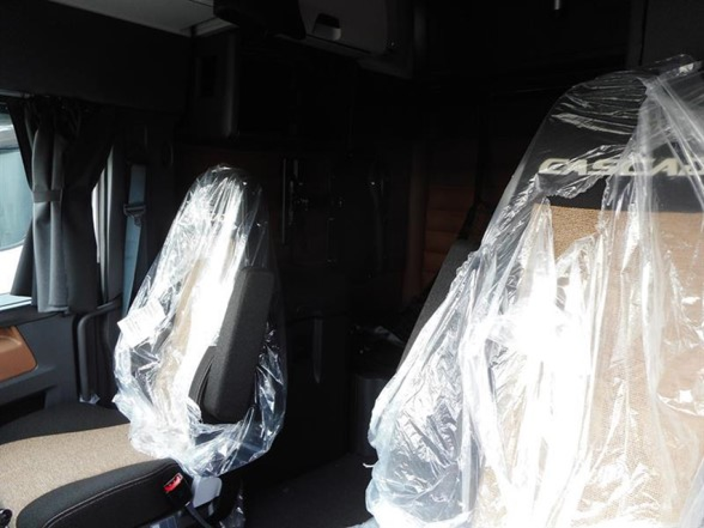 Freightliner Cascadia 126 truck interior showing wrapped driver and passenger seats