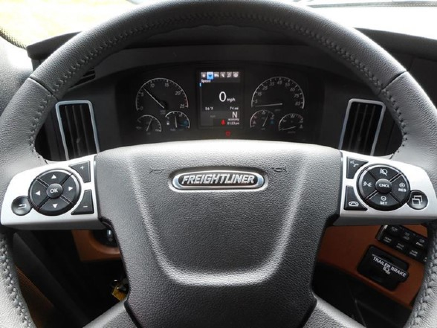 Freightliner Cascadia truck dashboard steering wheel center showing Freightliner logo and instrument cluster