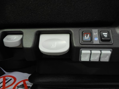 Freightliner Cascadia cockpit controls showing seat heater and adjustment switches.