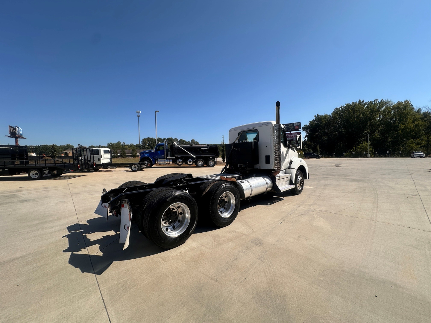 Kenworth T880 in 2-axle tractor configuration shown from rear-left side with white cab, chassis, and black wheels.