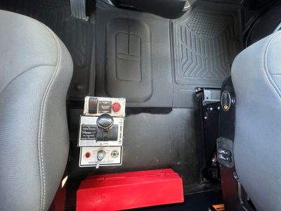 Kenworth T880 cab interior showing dash controls and red toolbox under center console