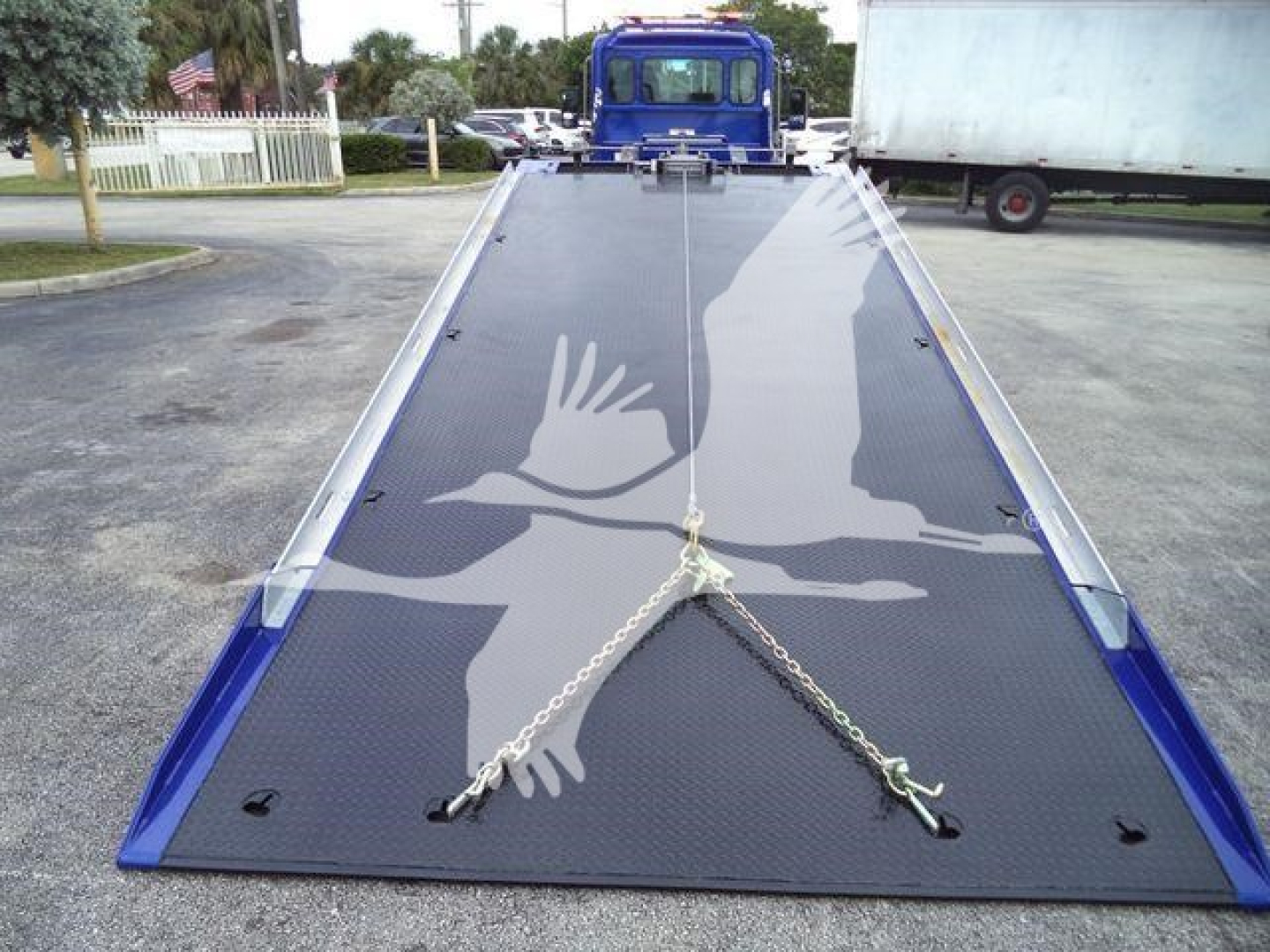 Kenworth T280 rollback truck flatbed with ramp access showing non-slip surface and loading setup.