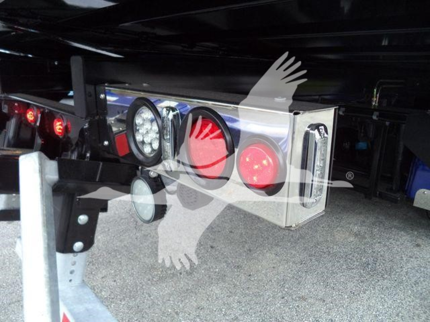 Kenworth T280 rollback truck rear lights and hitch assembly under trailer.