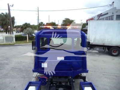 Kenworth truck cab in blue color with rollback equipment showing rearview and side windows.