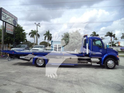 Kenworth T280 rollback tow truck side view showing blue cab and flatbed.
