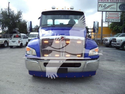 Kenworth T280 front view showing chrome grille, headlights, blue cab, and bumper; stock number KW2STEPSIDFM visible in listing context.