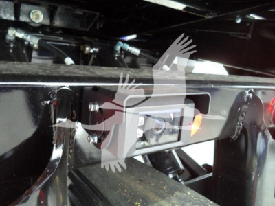 Nozzle and hitch area of a new Kenworth T280 truck frame showing mounting hardware and wiring near the rear of the cab chassis.