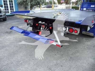 Trucking equipment showing rear of a 2025 Kenworth T280 rollback bed with hydraulic lifts and taillights visible.