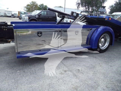 Kenworth T280 rollback truck side mirror image showing blue body panels and chrome storage compartments.