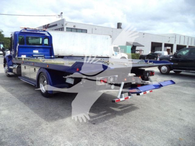 Kenworth T280 rollback tow truck with hydraulic rear bed and blue cab, showing side shelves and loading ramps.