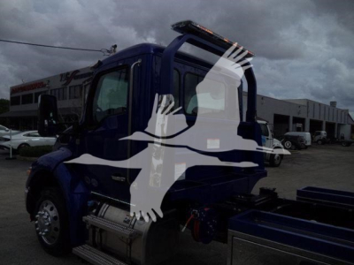 Kenworth T280 rollback truck side cab view with fuel tanks and steps visible; blue color.