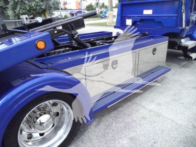 Kenworth T280 rollback truck side view showing blue body, steps, and storage compartments with chrome wheels.
