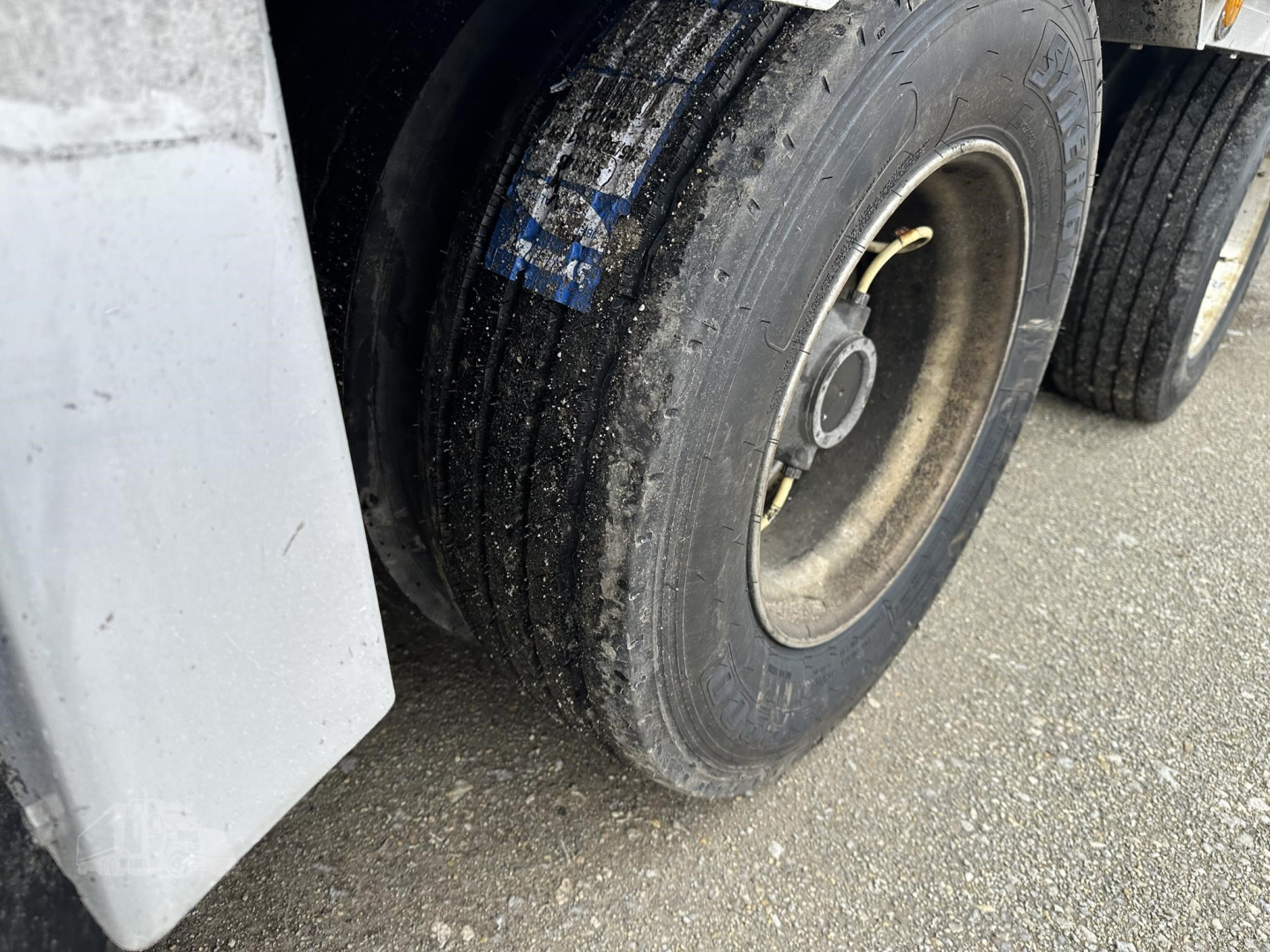 Trailer wheel and fender area of a 2019 Reitnouer Big Bubba drop deck trailer showing dual tires and a portion of the side skirt.