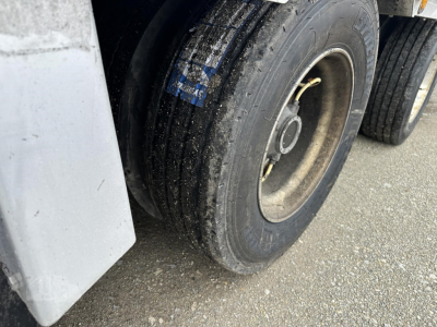 Trailer wheel and fender area of a 2019 Reitnouer Big Bubba drop deck trailer showing dual tires and a portion of the side skirt.